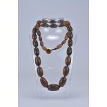 A certified strung Black Rhino horn beaded necklace together with certificate of authentication date