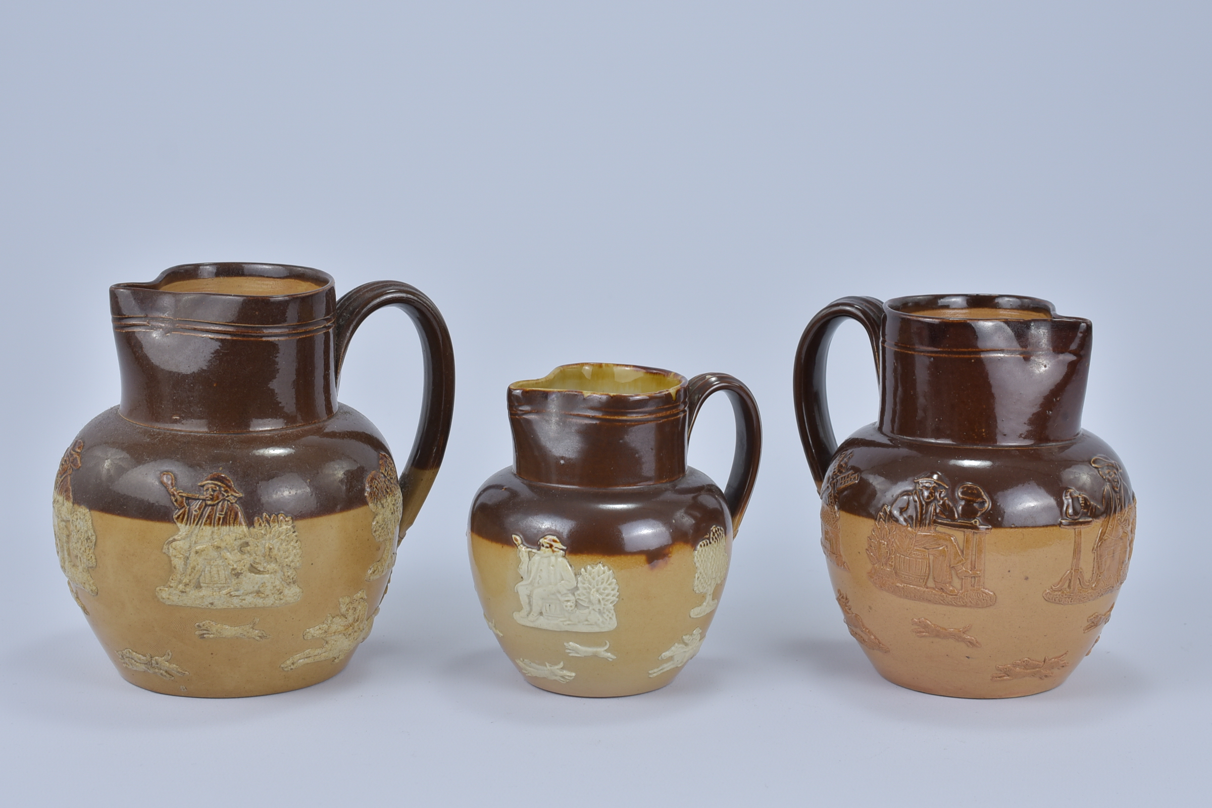 Three Royal Doulton Lamberth Stoneware Jugs. 11.4cm tall, 14cm tall, 14.5cm tall (3) - Image 2 of 3