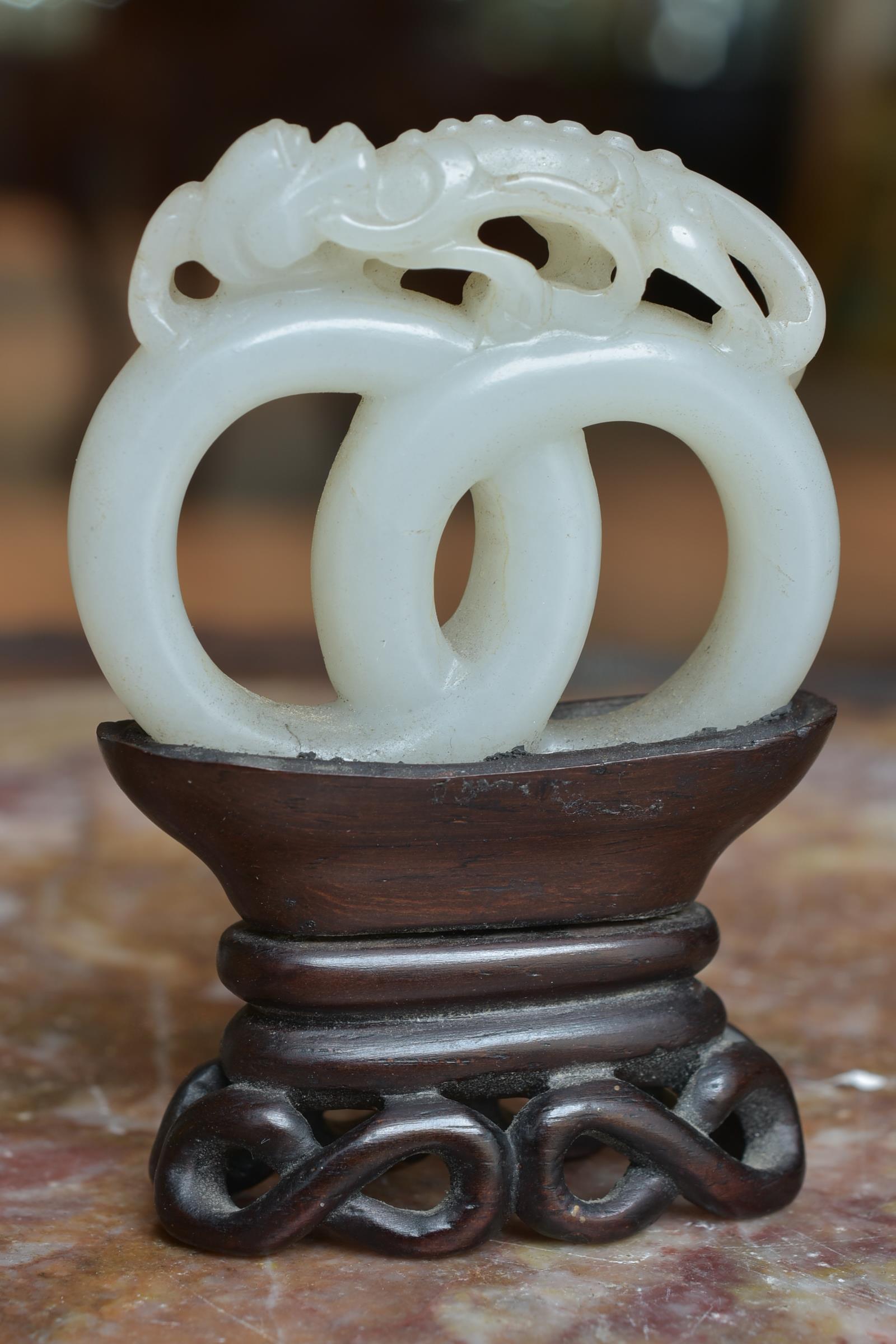 A 19th century Chinese carved White Jade joined rings surmounted by a dragon attached to wooden stan - Image 7 of 13