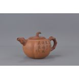 A 20th Century Chinese Yixing Teapot in the form of a pumpkin. Inscription and makers mark to base.