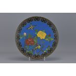 A Japanese Cloisonné Enamel dish decorated with two birds and flowers. 30cm diameter.