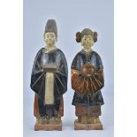 A pair of Ming dynasty style pottery figures of man and woman. (2)