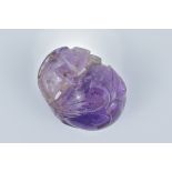 A cared Amethyst pendant in the form of a peach with lizard. 3.2cm x 2.5cm