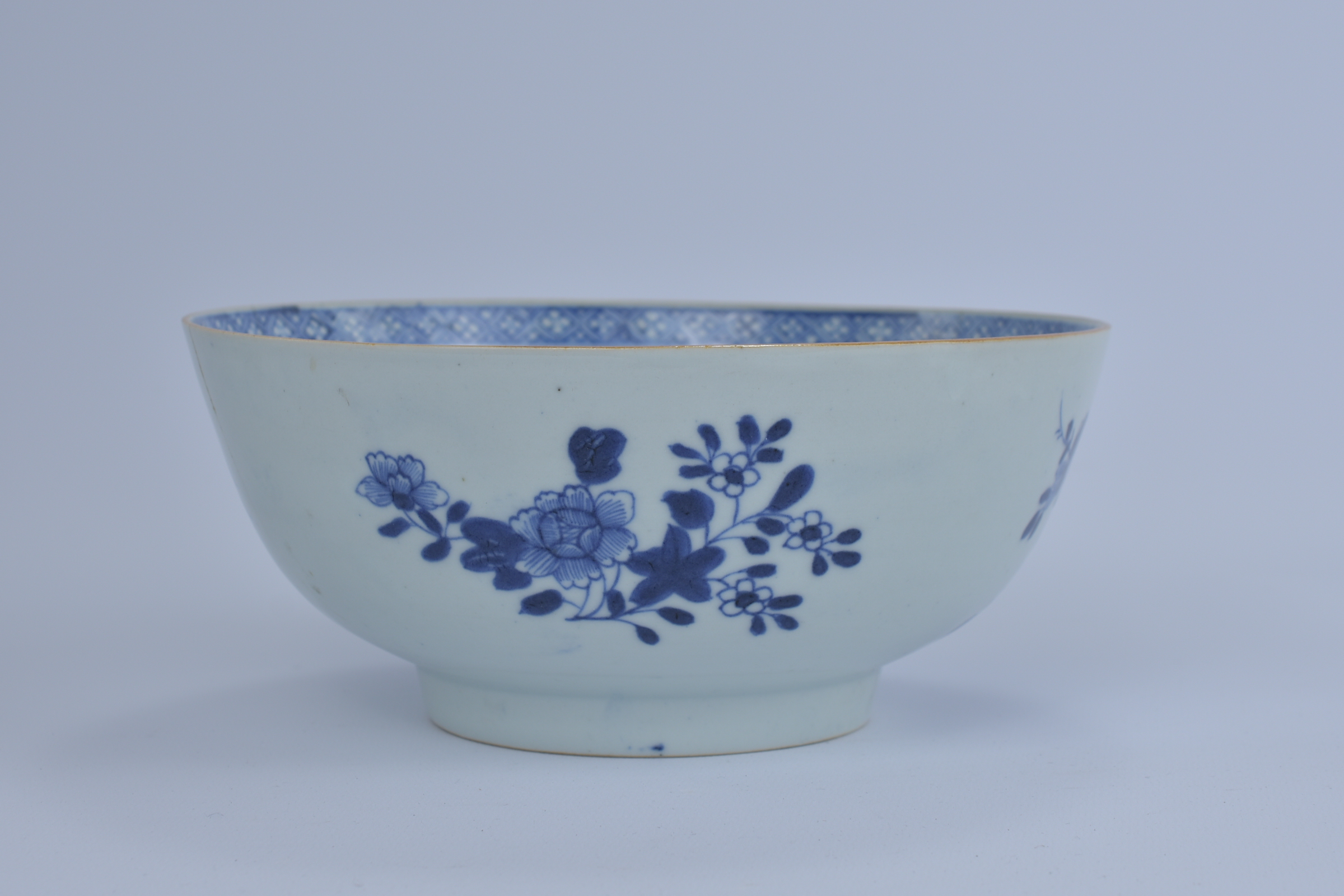 An 18th Century Chinese Blue and White export porcelain Bowl with garden and floral design. Kangxi p