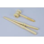 A set of ivory Glove Stretchers and miniature ivory gavel.