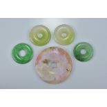 Five Chinese Jade disc pendants in various sizes and colours. 4.3cm, 2.5cm, 2.5cm, 2.3cm, 2.3cm