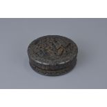 A 19th century Chinese carved tortoise shell ink box carved with court garden scene. 8cm x 3cm