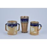 Three Royal Doulton stoneware blue glazed items. Including a three handle harvest jug, a mug and bea