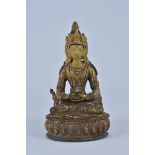A Tibetan gilt Bronze seated Buddha on Lotus stand. 18cm
