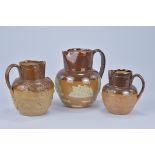 Three Royal Doulton Lamberth stoneware Jugs. 19cm tall, 14cm tall, 16.5cm tall (3)