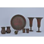 A group of seven Indian brass items including a single dish, pair of beakers, cups, fluted vases and