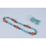 A string of Turquoise and carnelian beads with round pierced Silver spacers and silver and turquoise