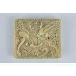 A finely carved Chinese 19th century Ivory Belt Buckle carved with four clawed dragon. Sliding belt