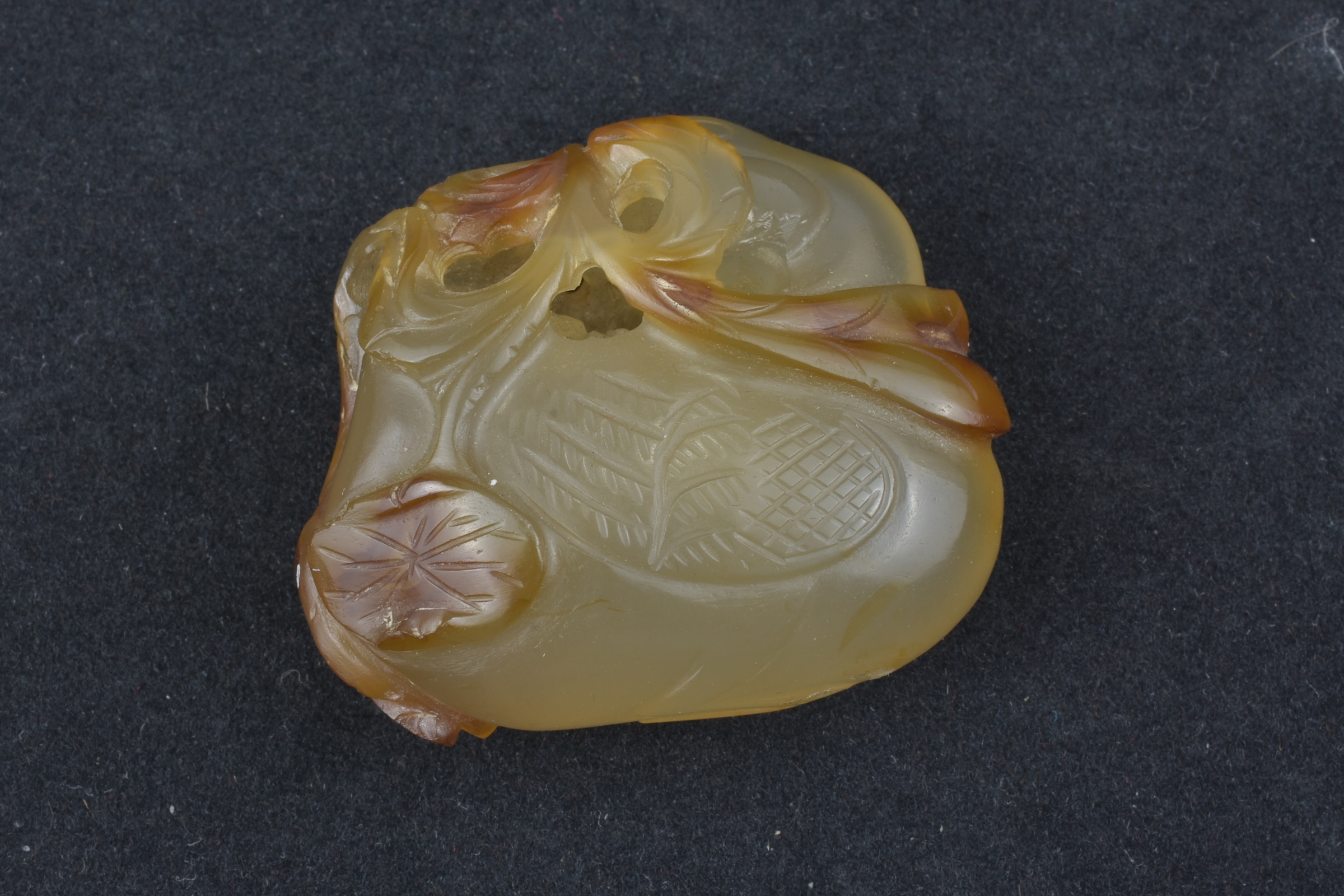 A 19th century Chinese light and dark brown Agate pendant carved as a Duck holding a lotus branch in - Image 13 of 14