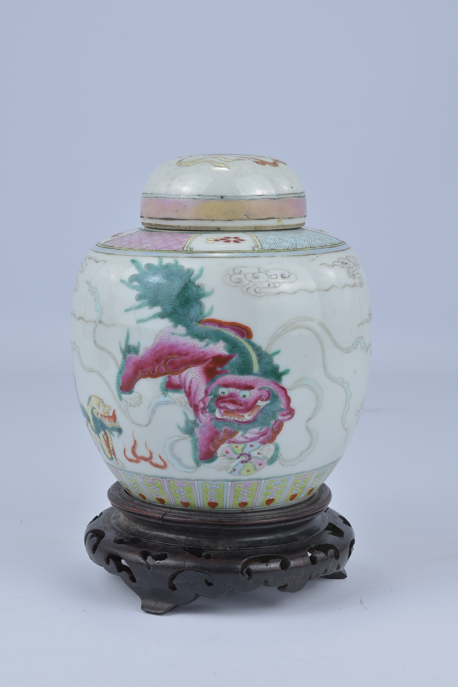 A 19th Century Chinese Famillie Rose porcelain Jar and Cover decorated with two kilin on wooden stan