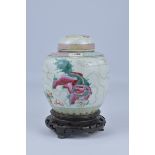 A 19th Century Chinese Famillie Rose porcelain Jar and Cover decorated with two kilin on wooden stan