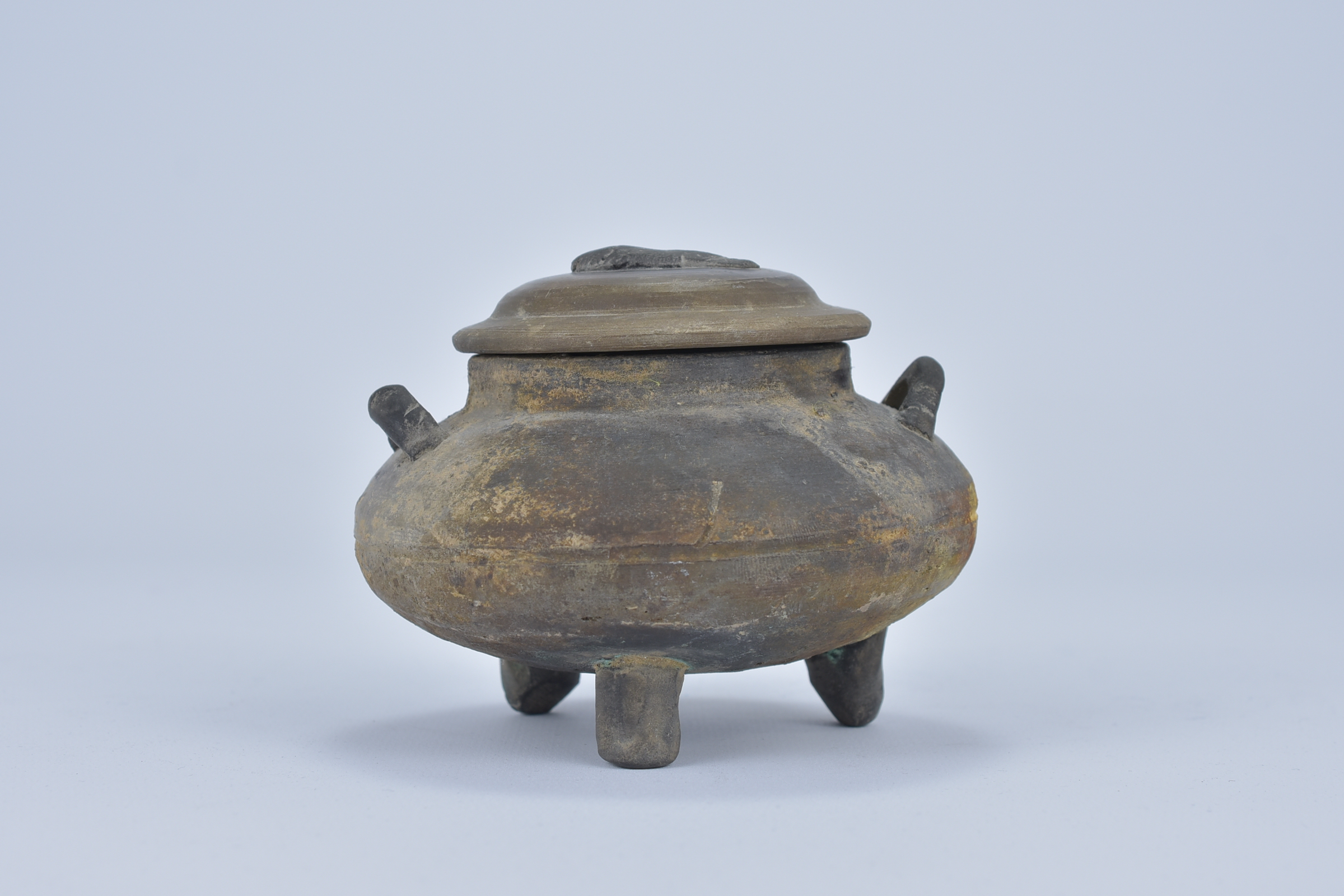 A Chinese Han Dynasty twin handled Grey pottery tripod pot with fish design cover. 8.9cm tall Proven