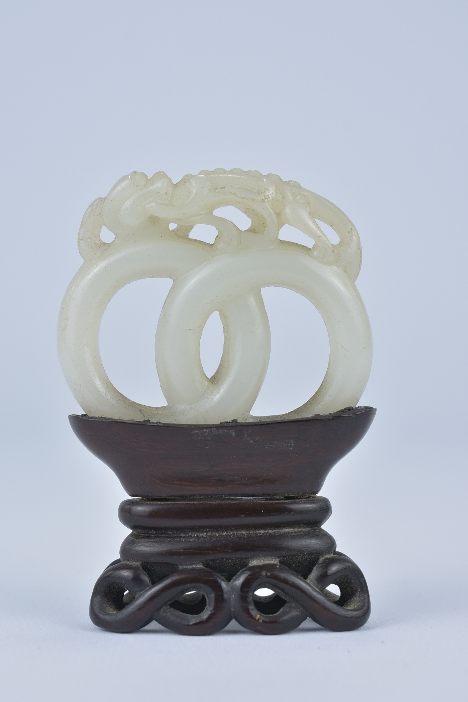 A 19th century Chinese carved White Jade joined rings surmounted by a dragon attached to wooden stan - Image 2 of 13