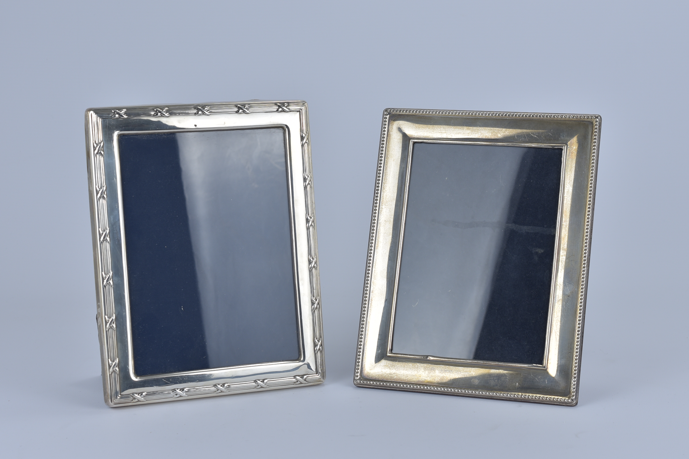 Two Sterling Silver picture Frame. One with 'Harrods' logo. 22.3cm x 17.5cm (2)