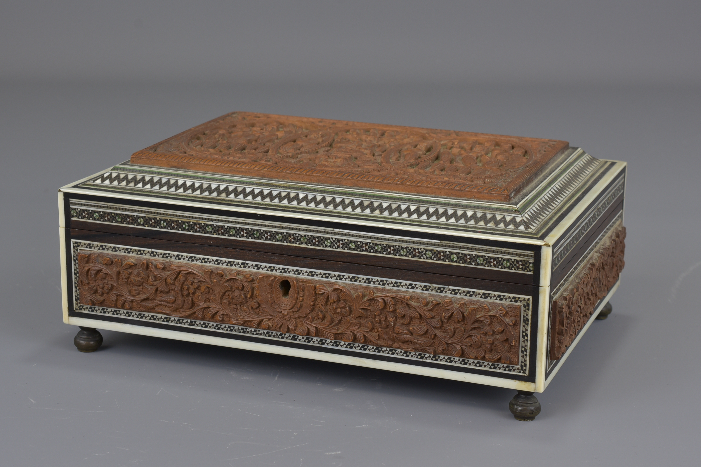 An Indian 19th century sandalwood box inlaid with bone and ebony. 22 cm length.