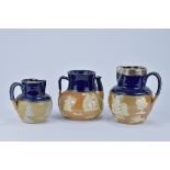 Three Royal Doulton stoneware blue glazed items. Including two jugs and one teapot and cover. 12cm t