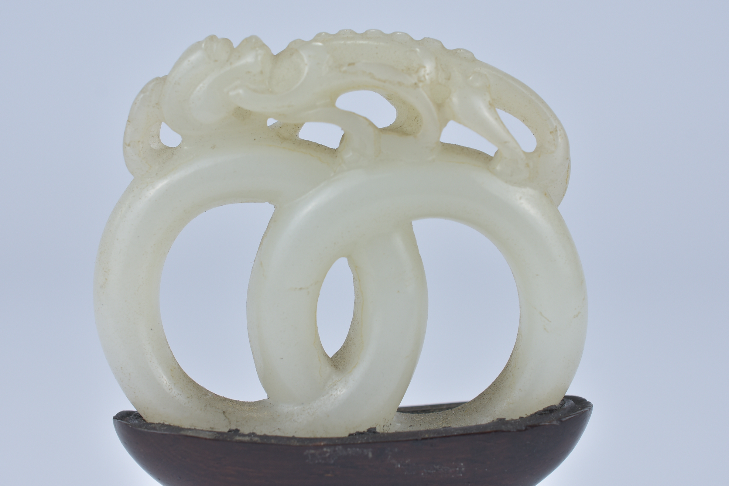 A 19th century Chinese carved White Jade joined rings surmounted by a dragon attached to wooden stan - Image 3 of 13