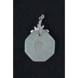 A Chinese carved jade pendant, octagonal shape with loose central jade stone. Mounted with 18K white