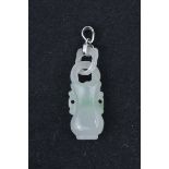 A Chinese carved jade vase shape pendant with jade loop, 18K white gold mount.