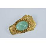 An antique Gold Brooch with central Jade cabochon stone. 4cm x 2.5cm