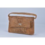 A vintage crocodile leather women's handbag with strap.