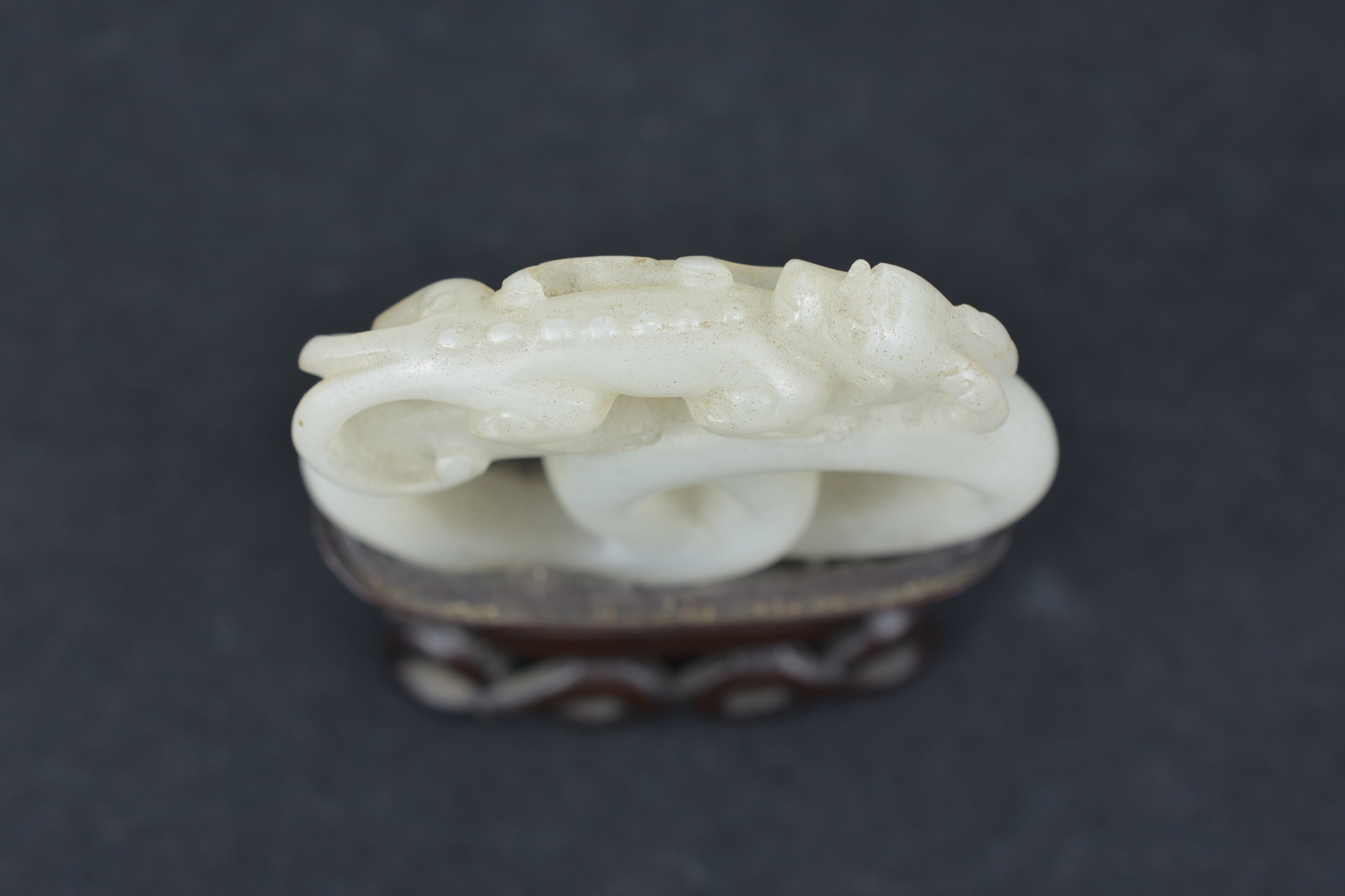 A 19th century Chinese carved White Jade joined rings surmounted by a dragon attached to wooden stan - Image 6 of 13