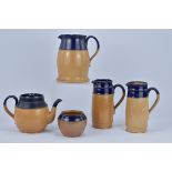 A group of five Royal Doulton blue glazed stoneware items. Including three jugs, a teapot and cover