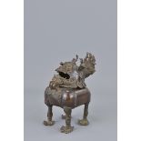 A Chinese bronze incense burner Ming Dynasty style in the form of a kilin. 13Cm x 15cm