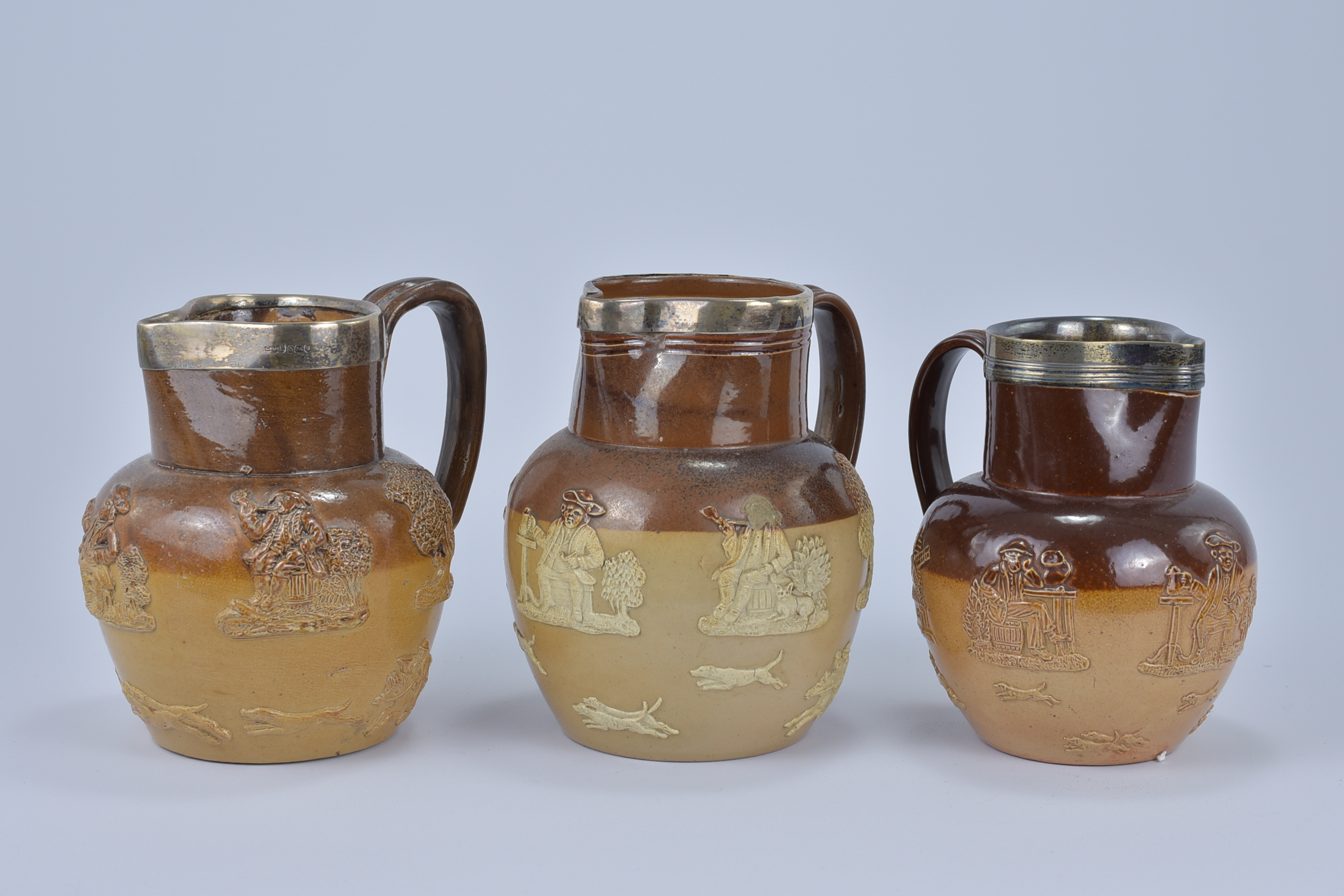Two Royal Doulton Lamberth stoneware Jugs with stamped silver rims. 16cm tall, 16.4cm tall, 17cm tal - Image 2 of 5
