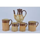 A Royal Doulton Coffee Pot and Four Royal Doulton Mugs. 18.9cm tall, 13.5cm tall x 8.8cm diameter, 1