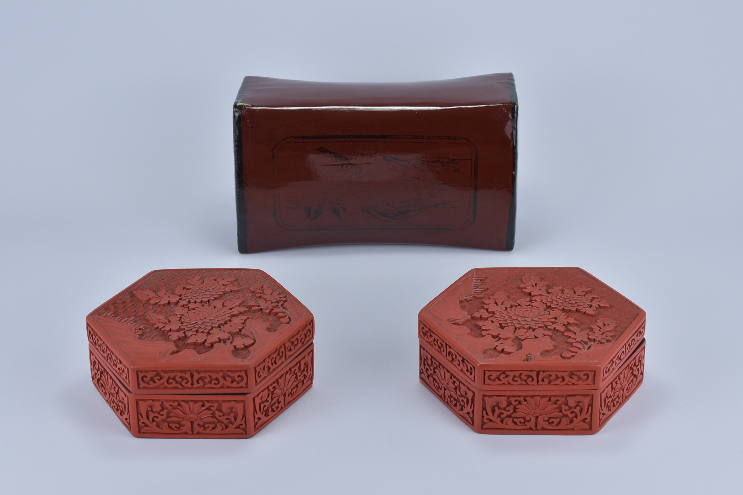 Two Chinese red Lacquer Boxes with floral pattern designs together with a Lacquer Pillow 15cm x 6.5c