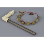 A Chinese Jade turtle string bracelet together with cared ivory parasol handle in the form of a drag