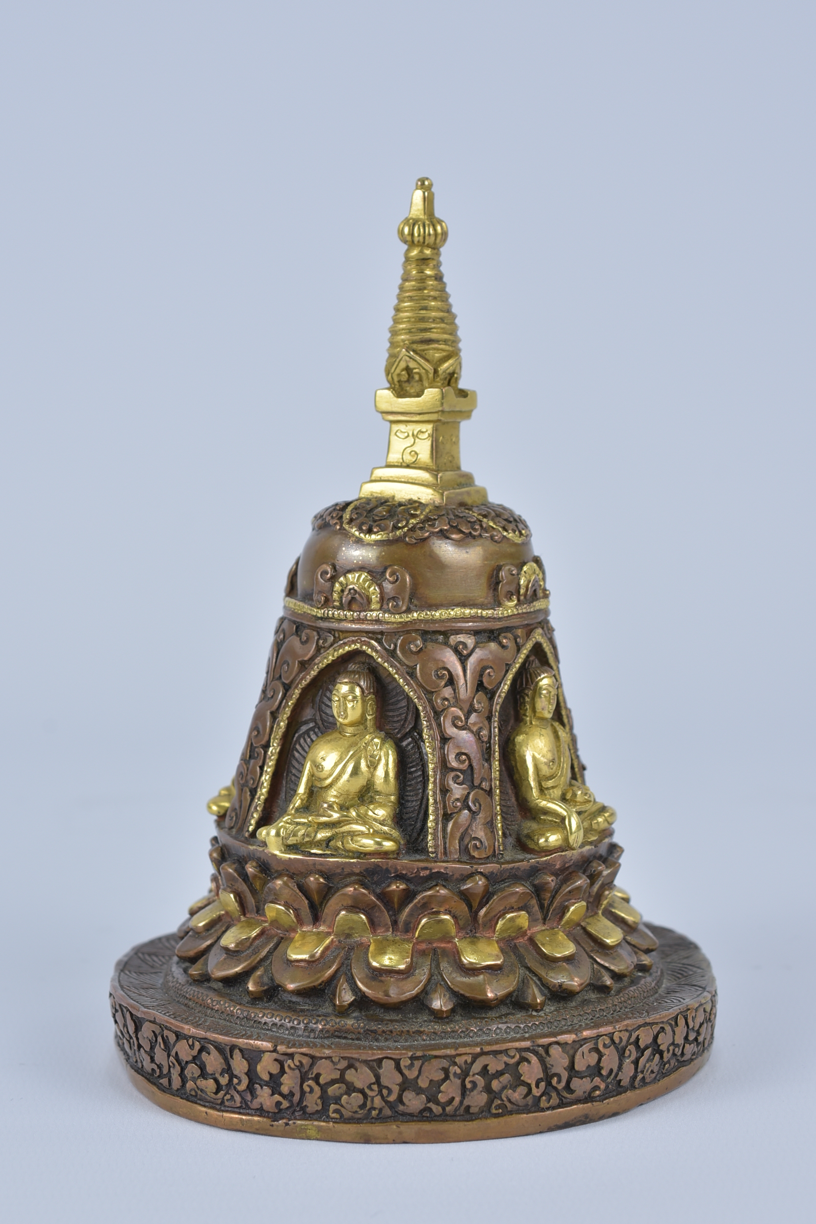 A Tibetan bronze pagoda statue with four seated Buddhas. 16cm height