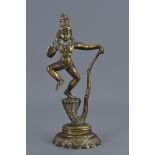 An antique South East Asian polished bronze figure