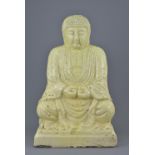 A 1920/1930 Japanese pottery seated Buddha with yellowish glaze. 47cm tall
