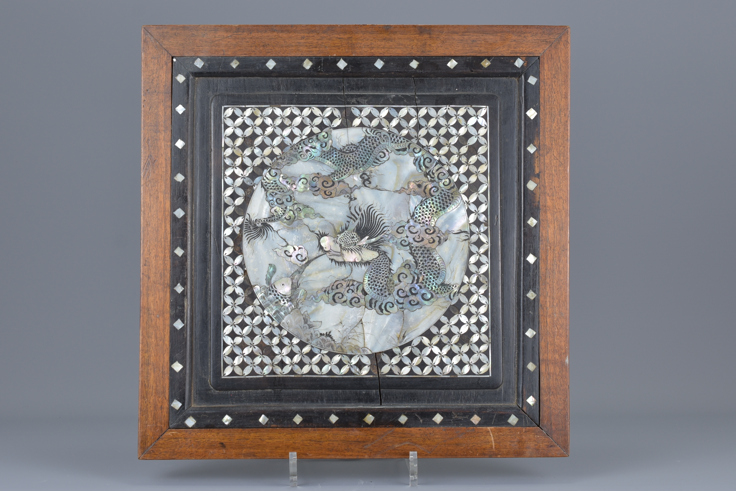 A framed mother of pearl inserted into hardwood panel decorated with dragon. 36.5cm x 37cm