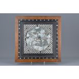 A framed mother of pearl inserted into hardwood panel decorated with dragon. 36.5cm x 37cm