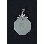 A Chinese carved jade pendant, octagonal shape with loose central  jade stone. Mounted with 18K whit