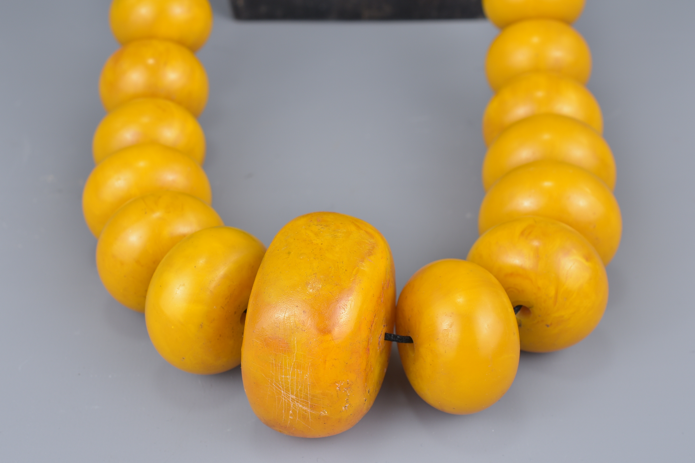 A large Moroccan amber resin bead necklace on string. - Image 2 of 3