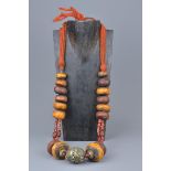 A large Moroccan amber resin and coral bead necklace with enamel silver metal pendant.