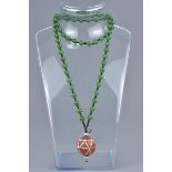 A string of jade beads together with an agate stone bead.