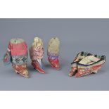 A pair of Chinese 19/20th century embroidered lotus shoes for bound feet together with three embroid