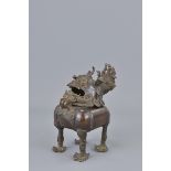 A Chinese bronze incense burner Ming Dynasty style in the form of a  kilin. 13cm x 15cm