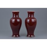 A pair of Chinese 19th Century red-glazed porcelain vases. 26cm tall