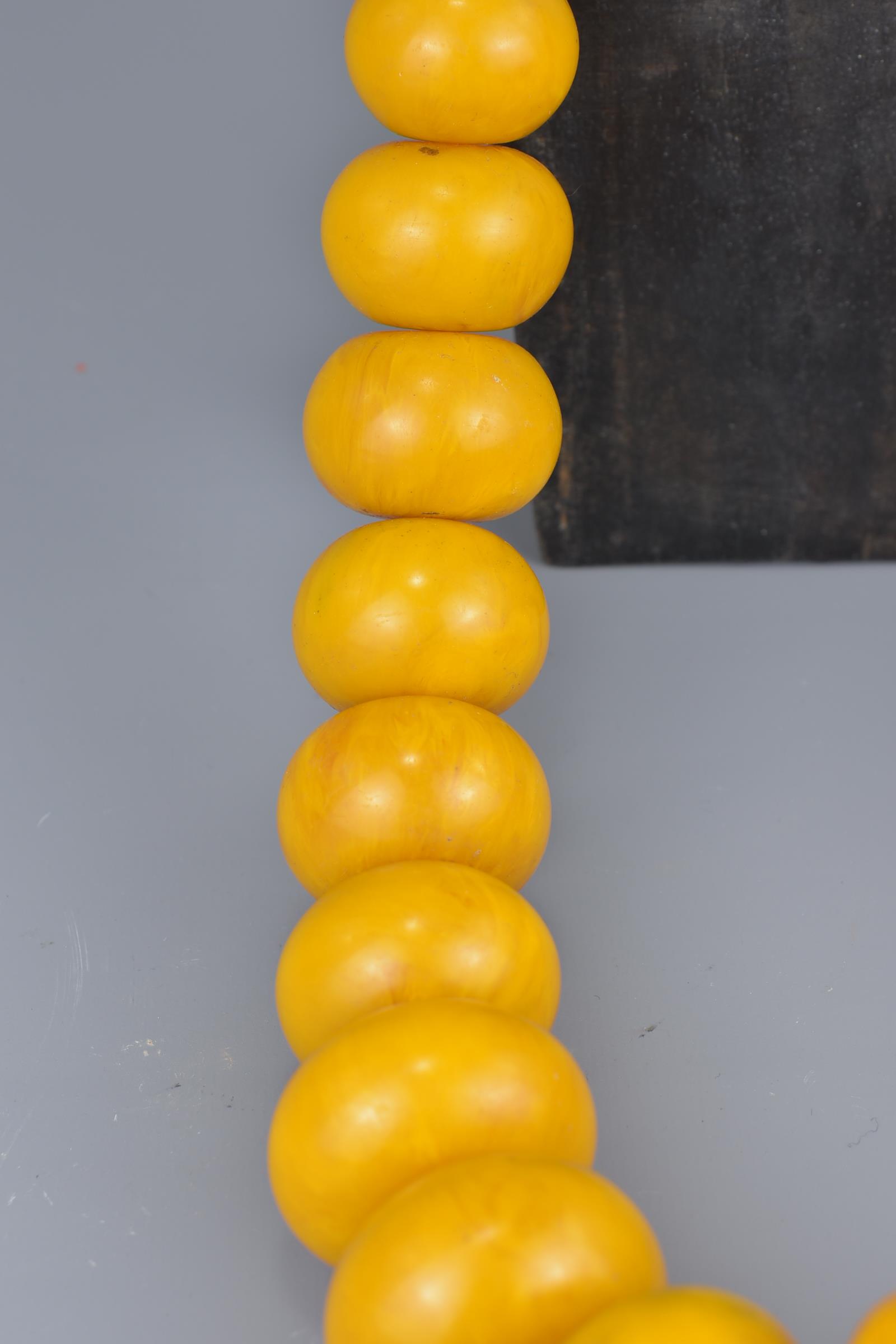 A large Moroccan amber resin bead necklace on string. - Image 3 of 3